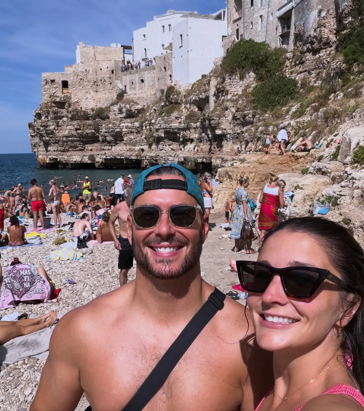 Drew and Valerie taking a selfie at a crowded cove beach